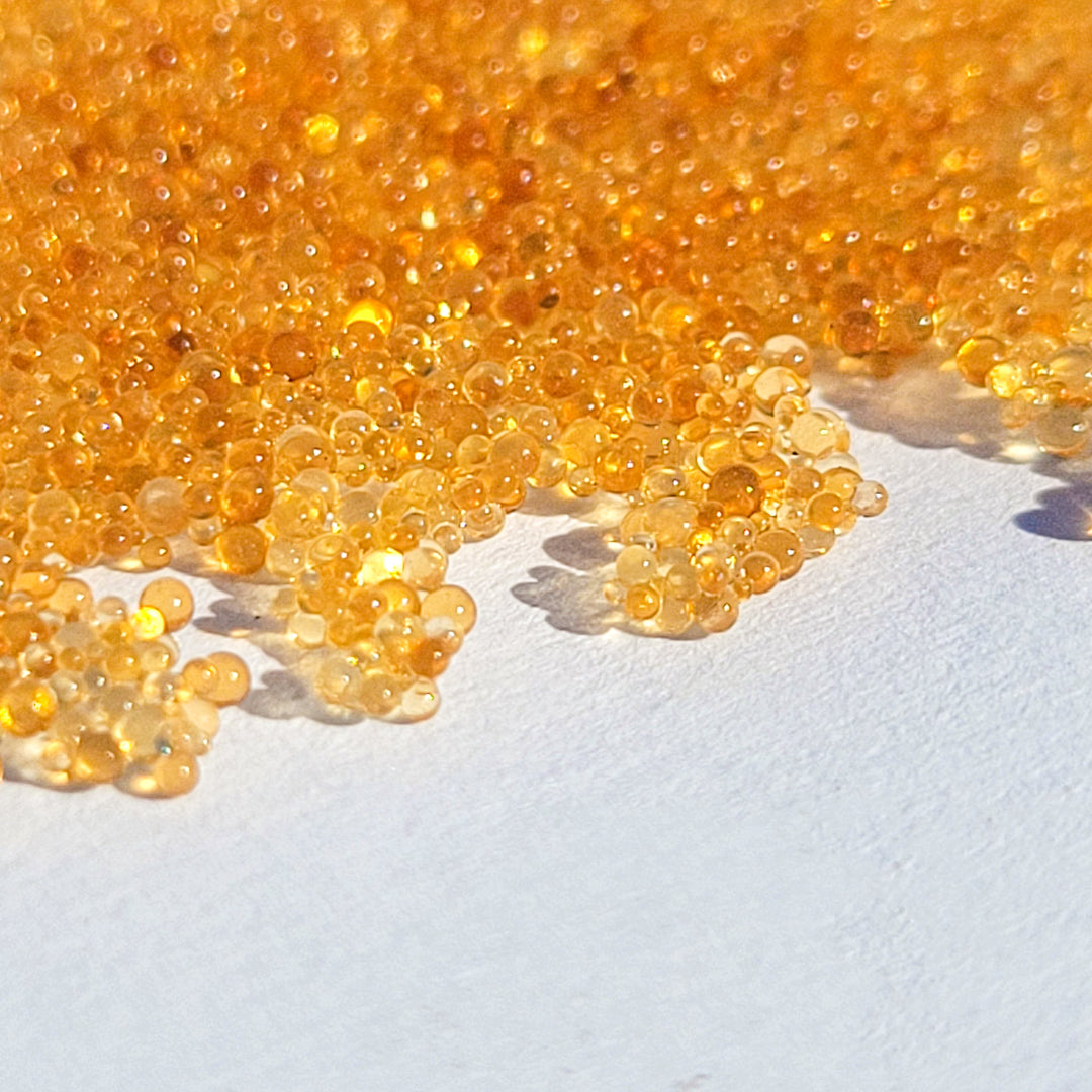 Close-up of Tulsion® CAM-401 mixed-bed resin beads used in water purification for window cleaning systems.