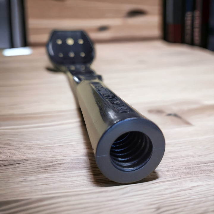 The threaded end of "The Gutter Cleaner" tool showing the acme thread designed to attach to extension poles, resting on a wooden surface.