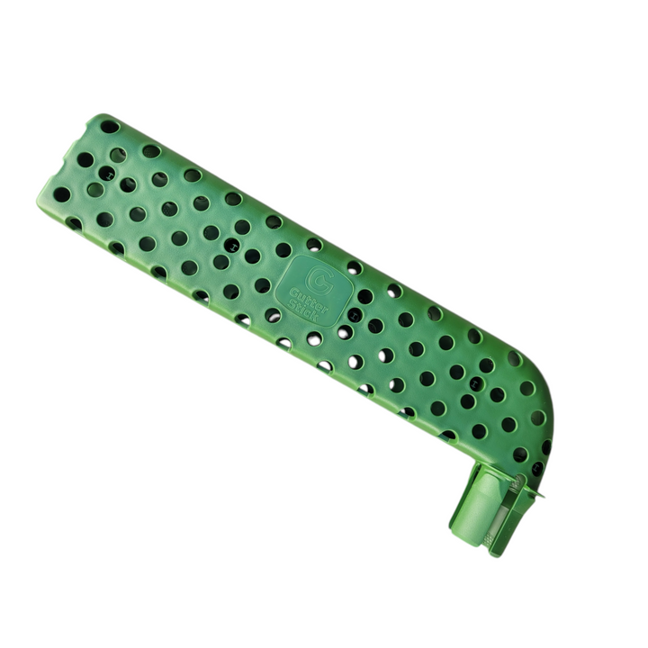 A green, elongated, perforated plastic device designed to fit into a gutter downspout. It has a curved end and multiple holes throughout its body for continuous water flow.