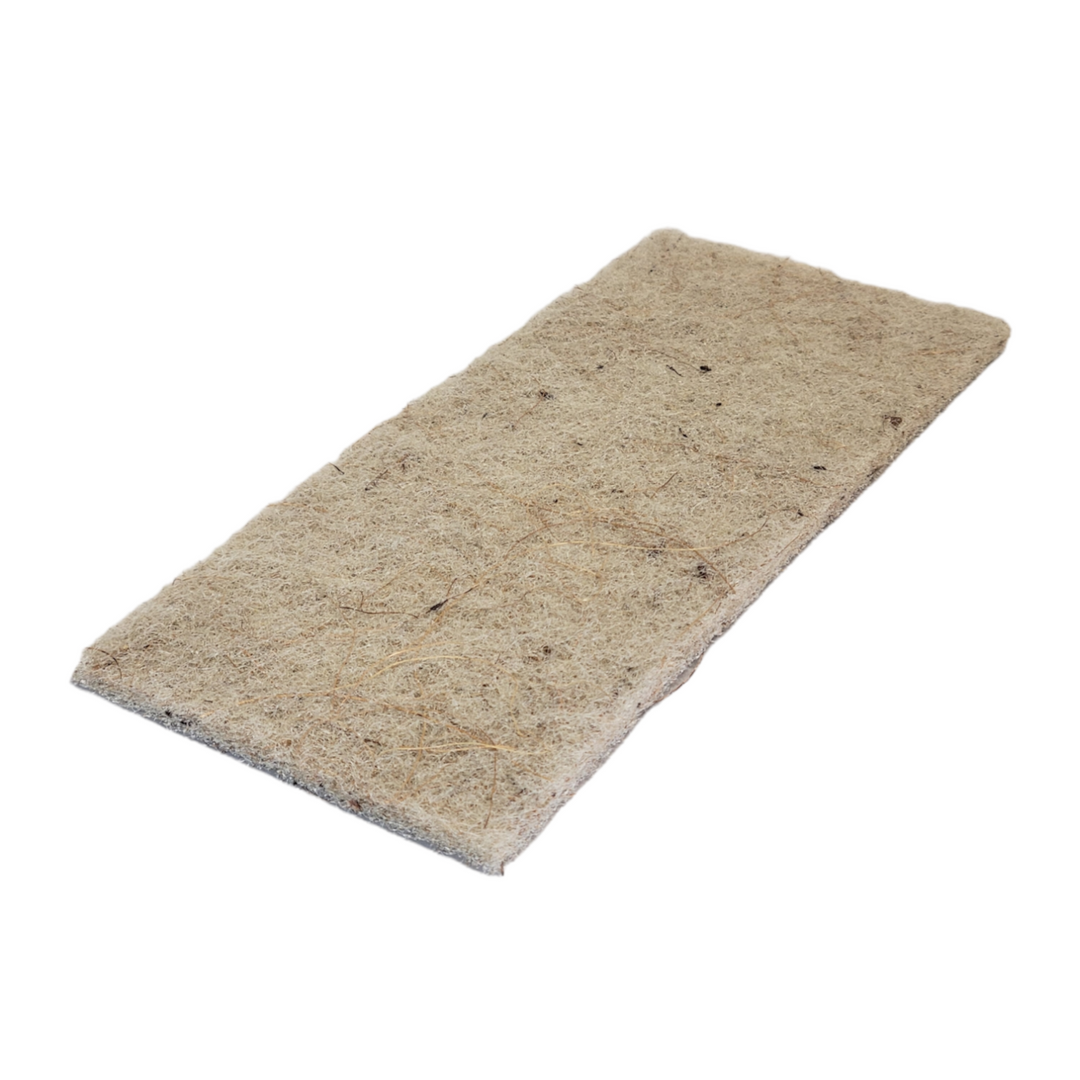 A rectangular eco-friendly scouring pad made of coconut husk fibers, with a coarse texture, displayed on a white background.