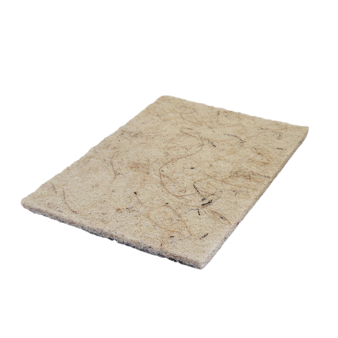A 6in by 9in coconut husk scouring pad.