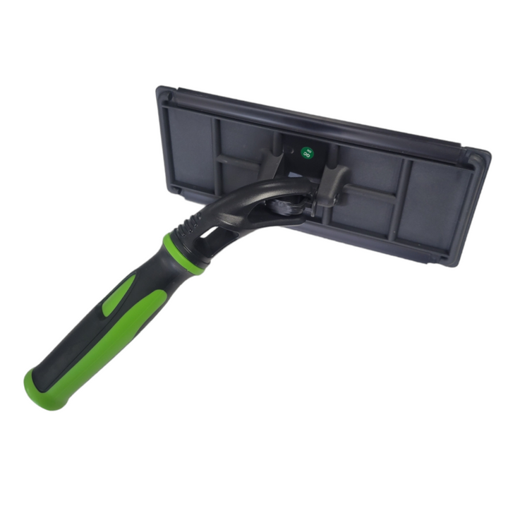 Professional cleaning tool with a black rectangular pad holder and a green and black rubberized handle that articulates. The tool is displayed against a white background, emphasizing its sleek design.