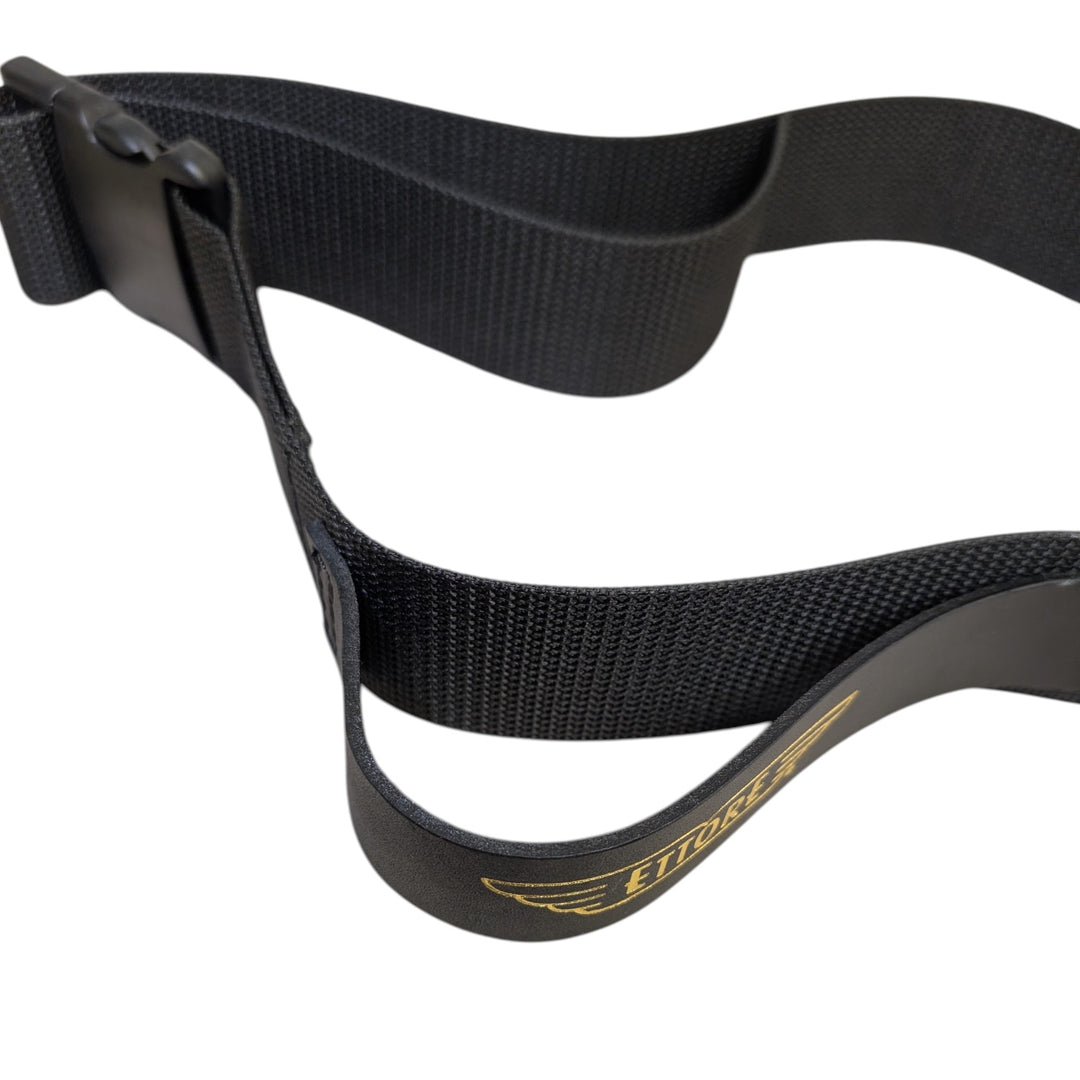 Close-up of a black woven nylon belt with a black plastic buckle and a gold logo reading 'ETORRE' on a white background.