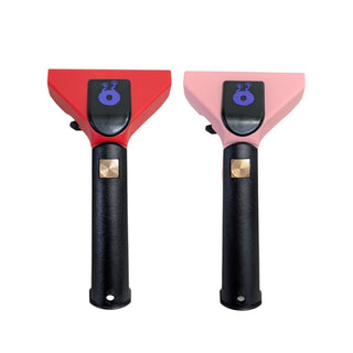 Two handheld plastic squeegee handles shown side by side on a plain white background. The left tool has a red upper section and the right tool has a light pink upper section, both with black handles and small metallic gold square accents.