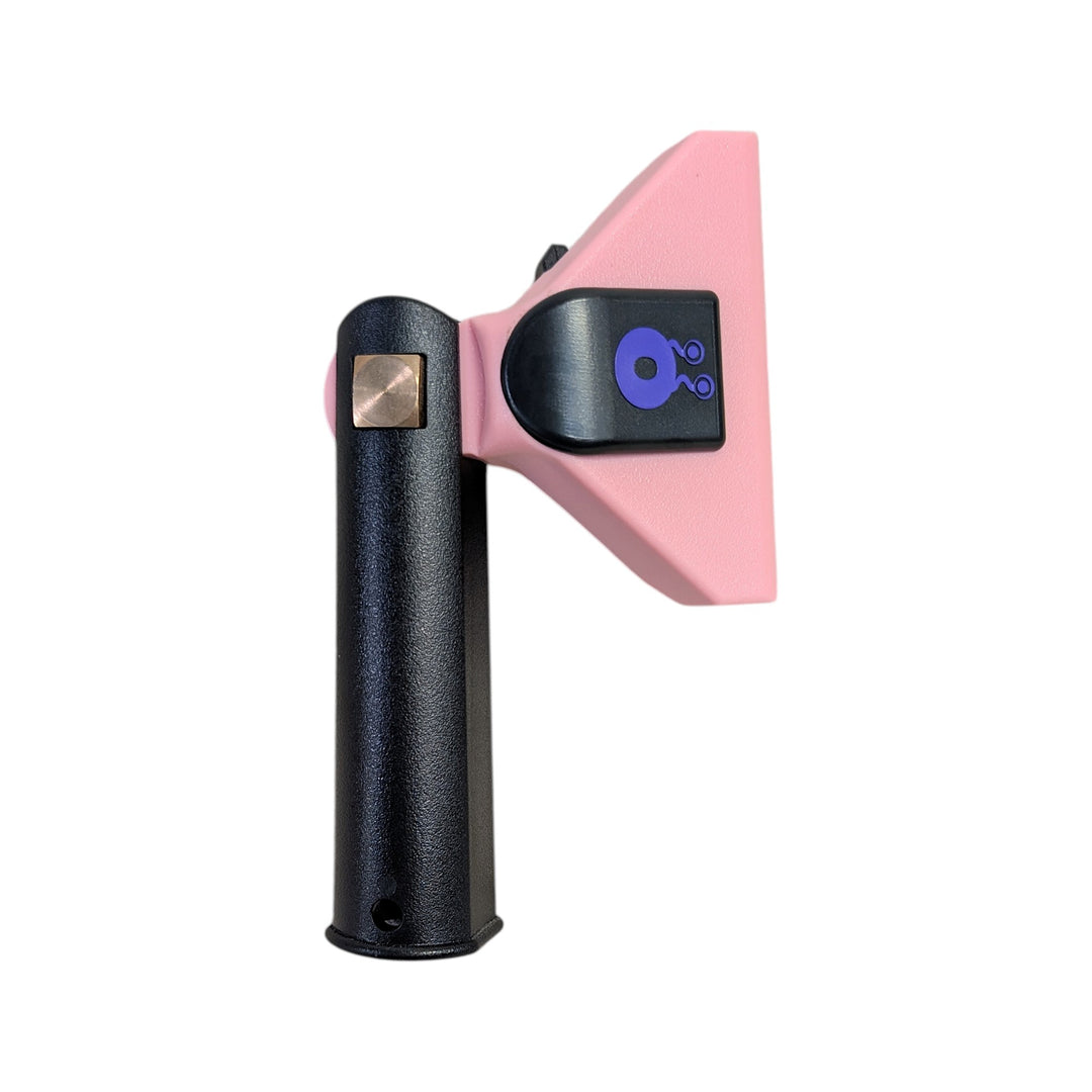 A handheld squeegee tool with a textured black handle, a pink angled head, and a black emblem featuring a blue droplet logo, isolated on a white background.