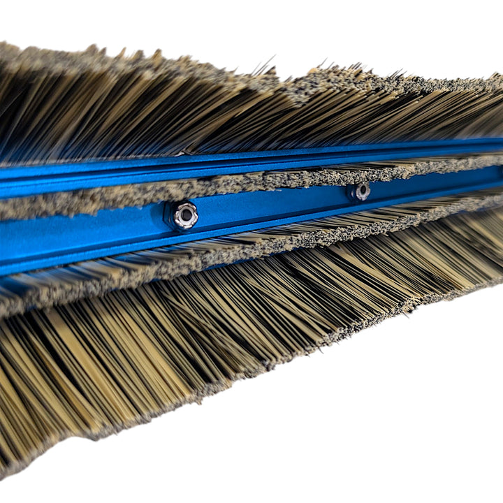 Underside close-up of the PWP Swivel Lite brush showing dense synthetic bristle rows and two recessed fittings.