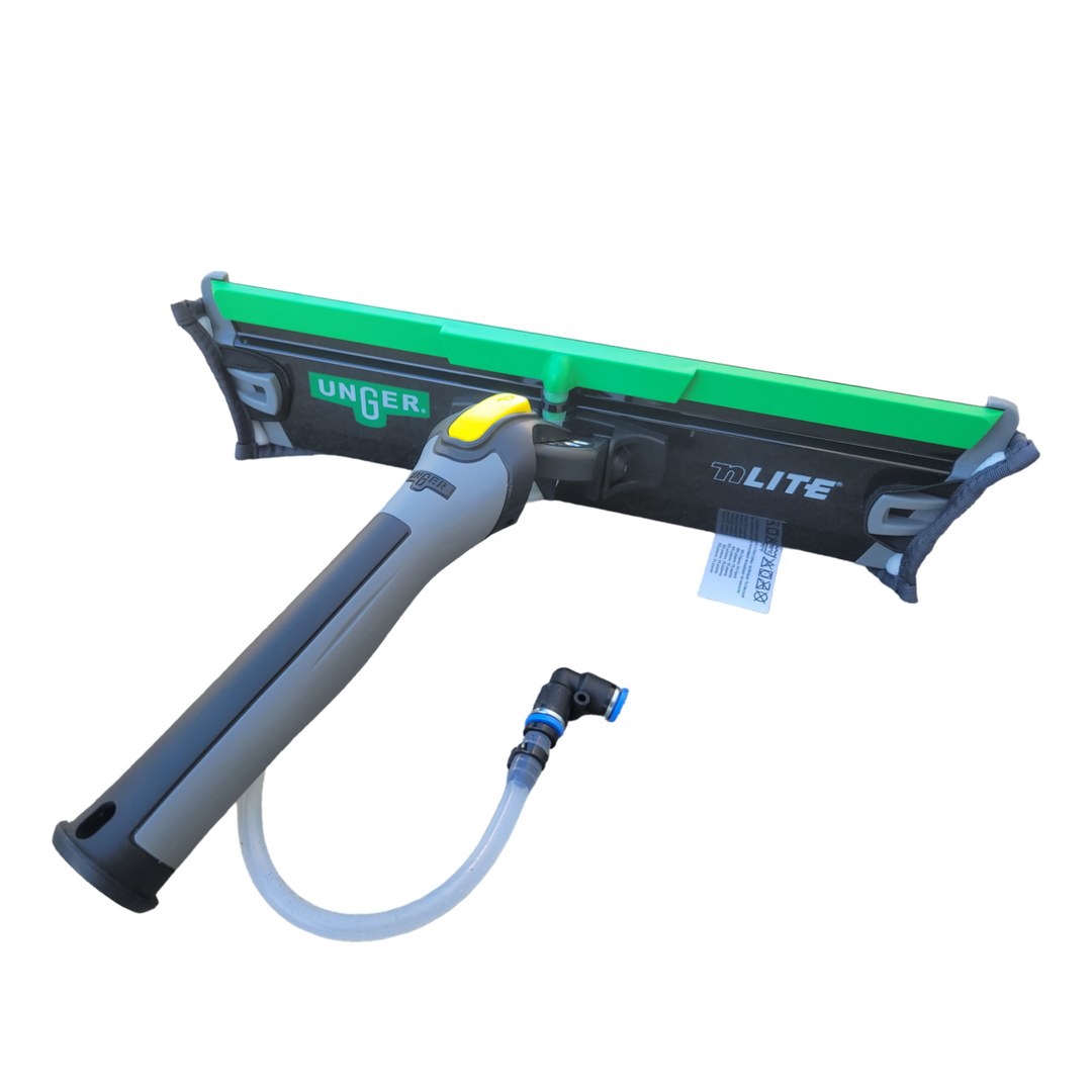 An angled view of the Unger PowerPad Complete window cleaning tool. It features an ergonomic handle in grey with yellow and black accents, a green water rinse bar at the top, and an attached microfiber pad at the base. A transparent water hose with a blue quick-connect fitting is visible on the side.