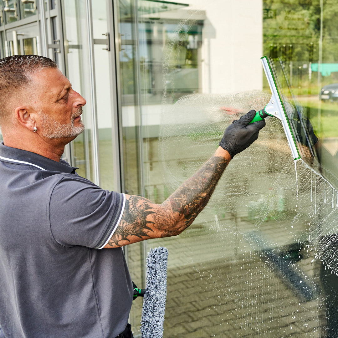 Window cleaner using an Unger ErgoTec squeegee on wet exterior glass