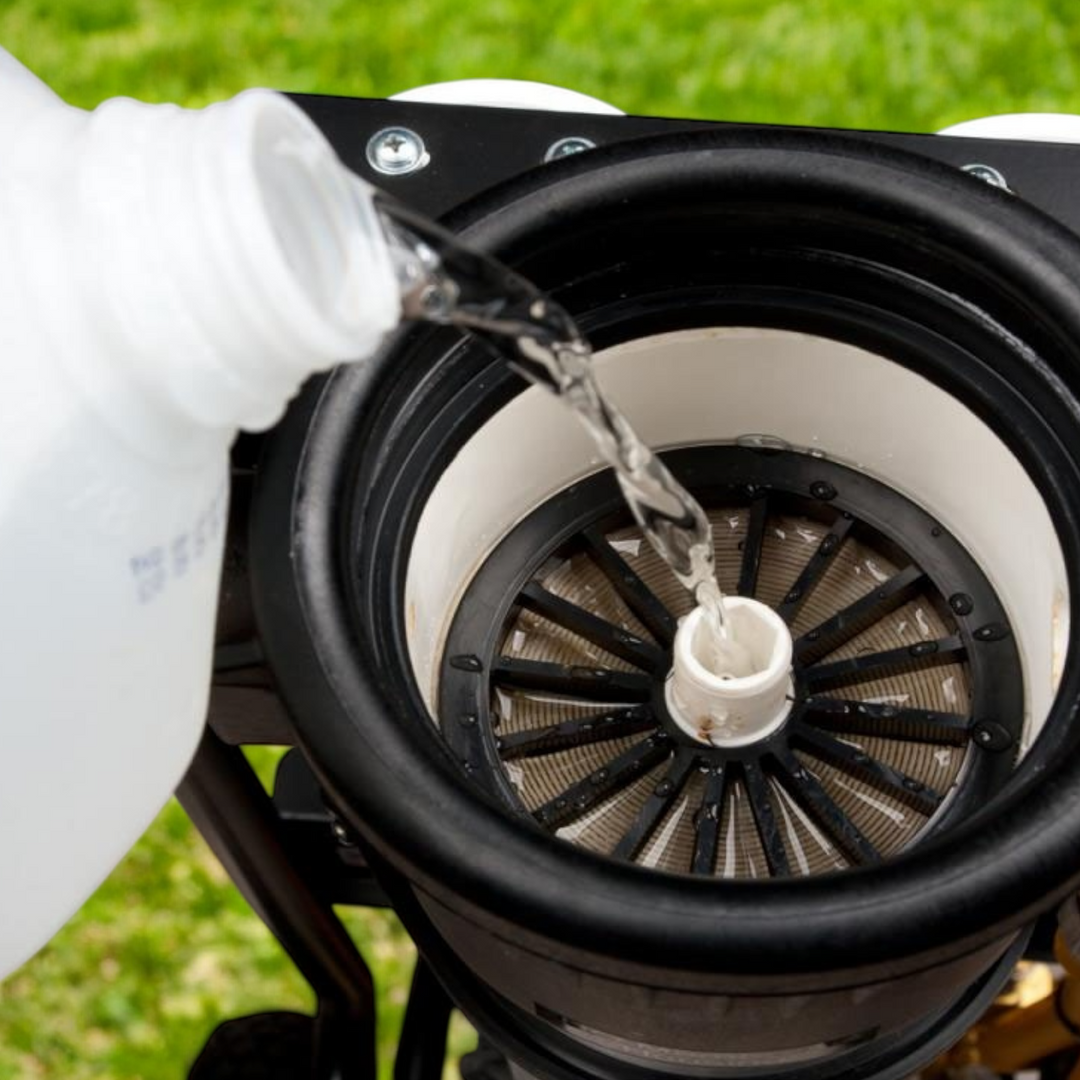 Liquid being poured from a gallon container into a filtration unit, illustrating the RO Protect solution being applied to a system for storage.