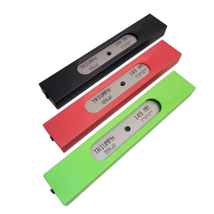 A collection of three plastic safety dispensers for scraper blades in black, red, and lime green, all with a stainless steel blade visible through the inspection window and 'Triumph 0.15 MM Stainless' branding.