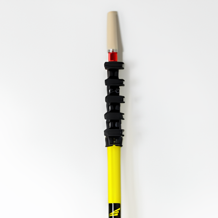 Vertical image of a yellow water fed cleaning pole with a beige traditional cone tip attached via a red adaptor, set against a white background.