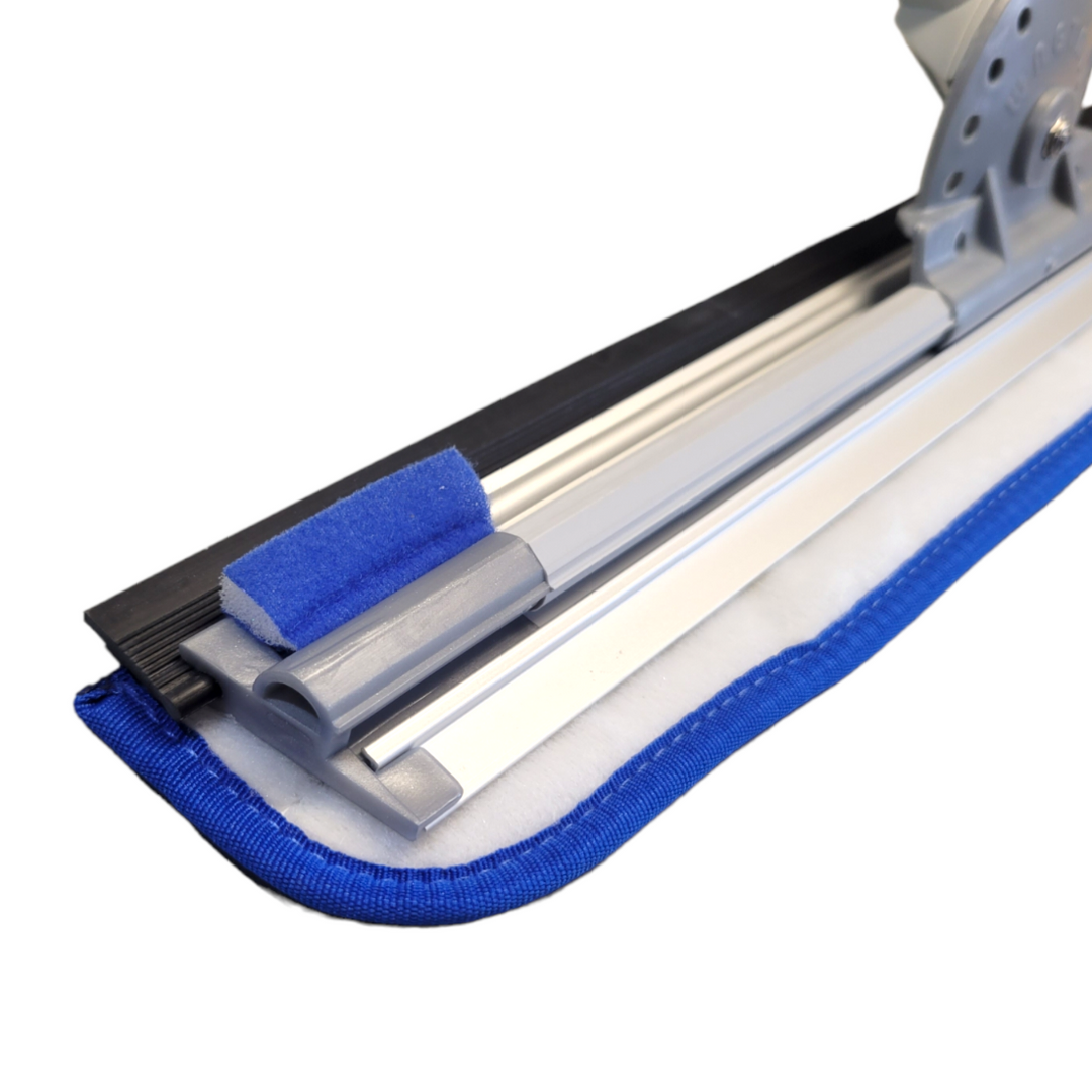  A close-up of the window cleaning tool's head, showing a blue microfiber pad, silver anodized aluminum channel, and grey rubber elements. The focus is on the tool's glide pad and squeegee mechanism.
