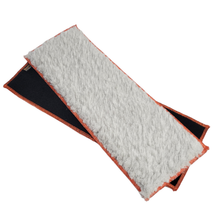A rectangular white microfiber mop pad with a black Velcro strip on the back and orange stitching along the edges. The pad is folded over to show both the front cleaning surface and the back attachment side.